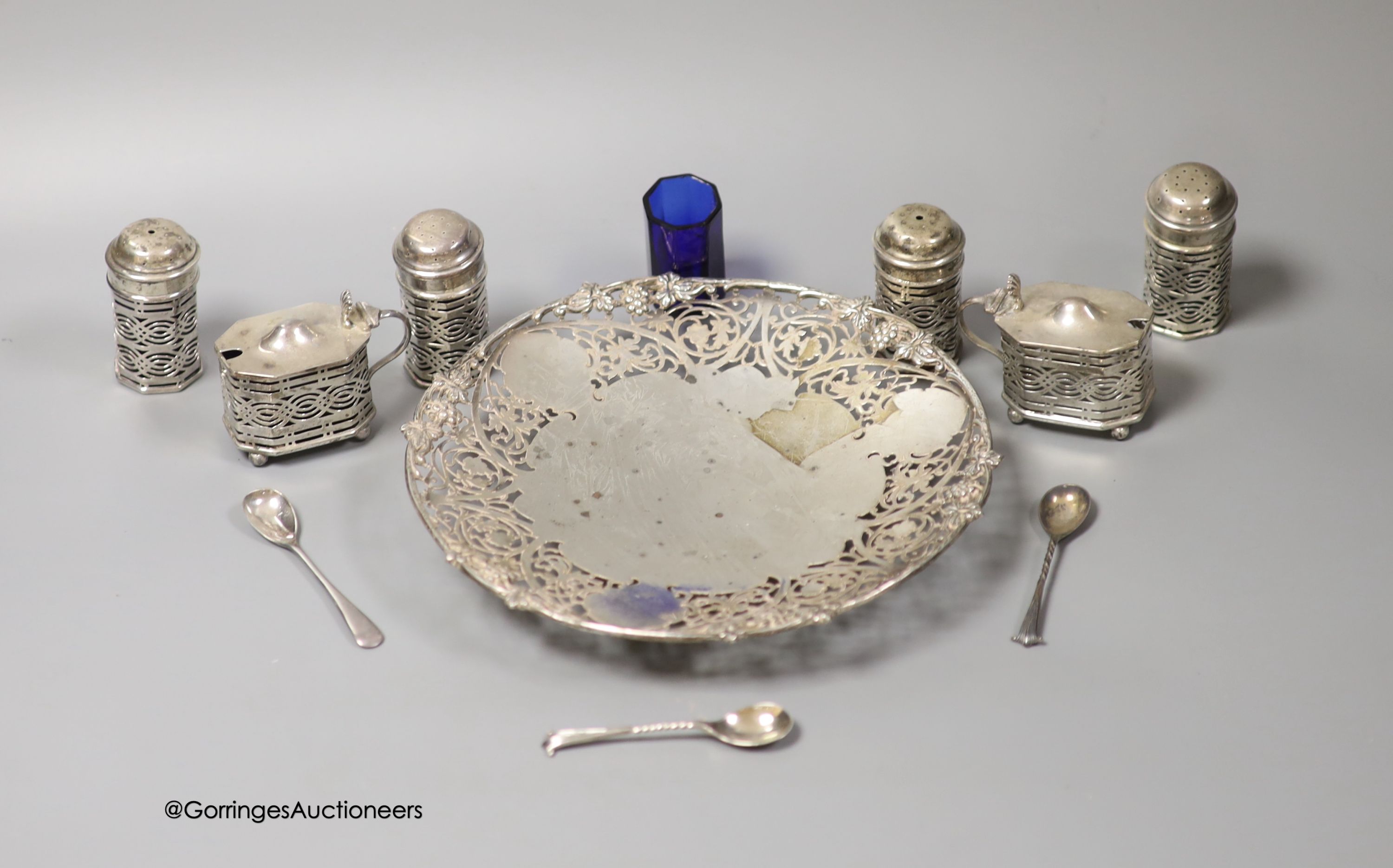 A modern pierced silver shallow dish, S.J. Rose & Son, Sheffield, 1964, 20.3cm and a late Victorian silver six piece condiment set, with two spoons, Birmingham, 1897, one liner missing and one extra liner